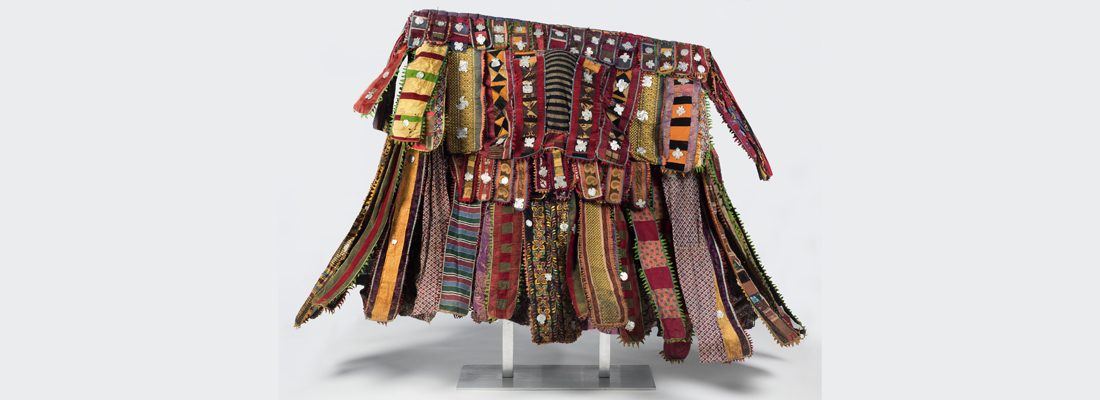 Yorùbá artist. Egúngún Masquerade Dance Costume (paka egúngún), circa 1920–48. Lekewọgbẹ compound, Ògbómọ ṣọ́, ỌTyọ́ State, Nigeria. Cotton, wool, wood, silk, synthetic textiles (including viscose rayon and acetate), indigo, and aluminum. Brooklyn Museum; Gift of Sam Hilu, 1998.125.