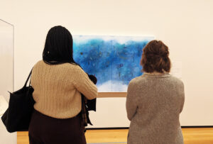 Two women looking at art